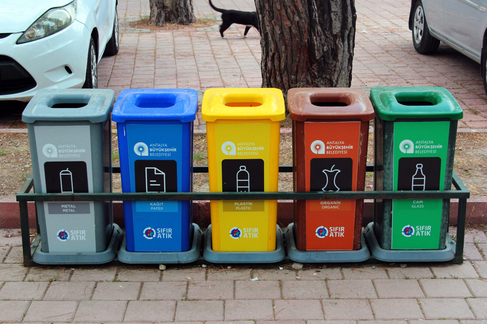 Five waste bins for sorting recyclable materials at Sarisu Beach, Konyaalti, Antalya, Türkiye. (Adobe Stock Photo)