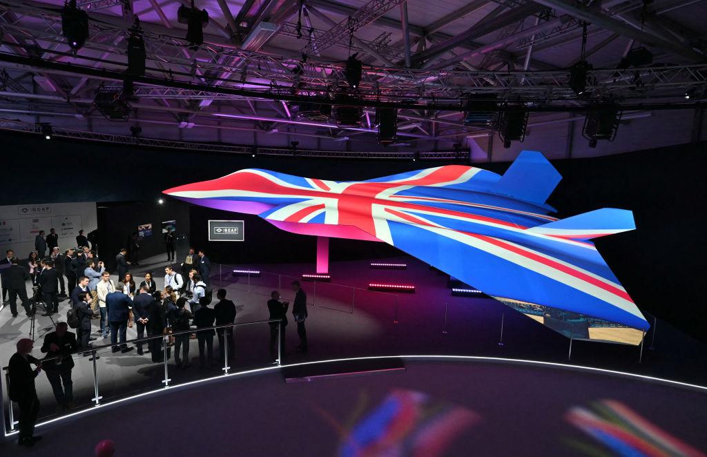 Attendees view GCAP concept fighter plane at the BAE Systems pavilion at Farnborough International Airshow, in Farnborough (AFP Photo) 