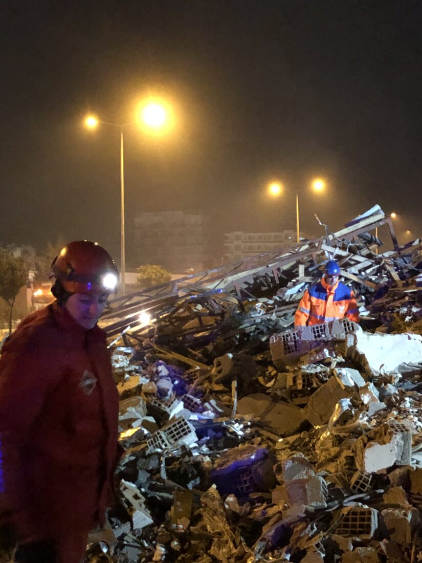SAR volunteer Basak Karasen aiding Dutch volunteers during the search through debris at night, illuminated by streetlights, Antakya, Türkiye, Feb. 2023. (Courtesy of SAR)SAR and Dutch volunteers work through the night to find survivors following the 2023 earthquakes, Antakya, Türkiye, Feb. 2023. (Courtesy of SAR)
