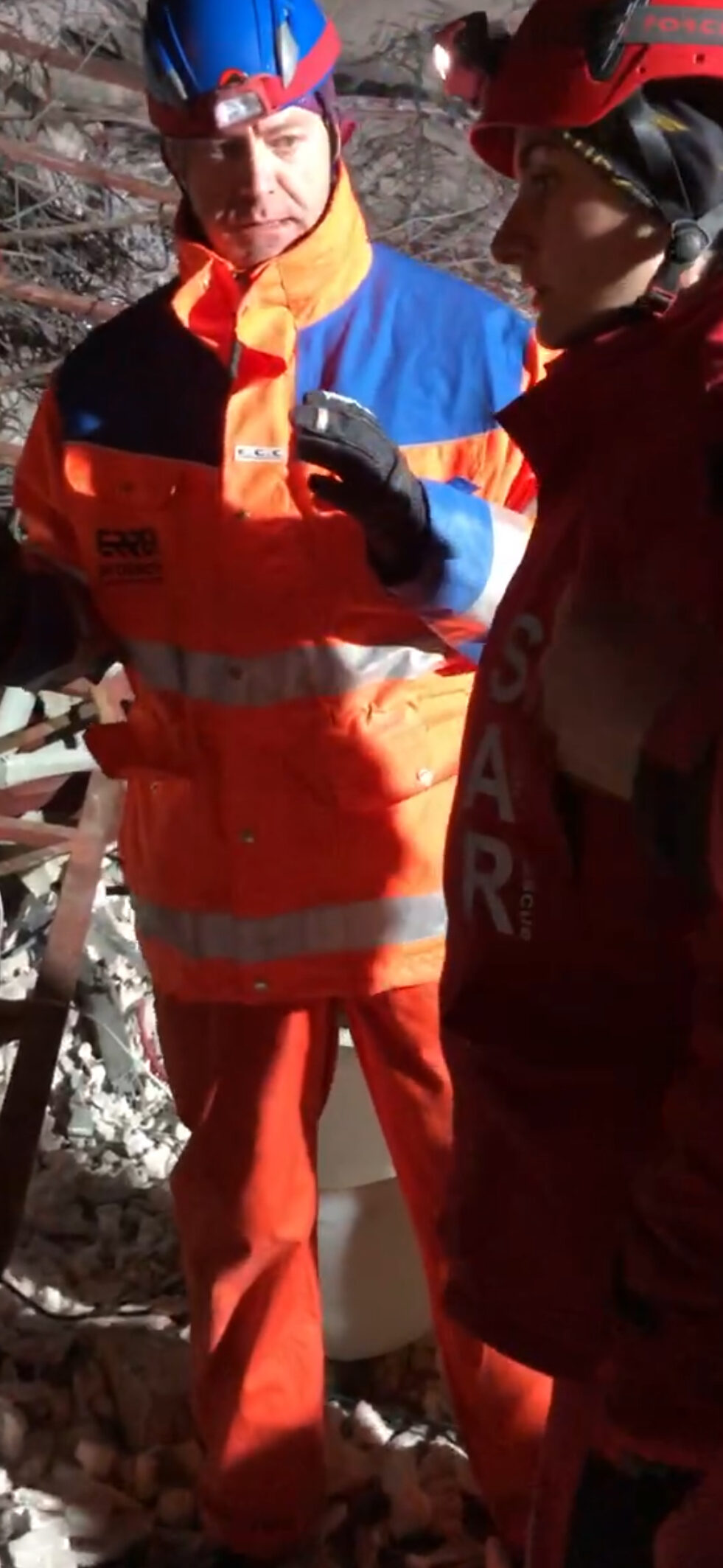 SAR volunteer Basak Karasen translates to Dutch rescue team in the disaster zone, Antakya, Türkiye, Feb. 2023. (Courtesy of SAR)A SAR volunteer speaks with Dutch rescue volunteer in the earthquake zone, exhaustion visible after days of relentless search efforts, Antakya, Türkiye, Feb. 2023. (Courtesy of SAR)
