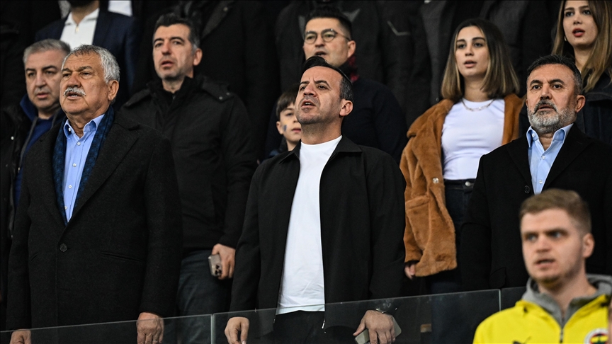 Adana Demirspor president Bedirhan Durak (center) stands with club officials and fans during the national anthem before a match, Türkiye, Feb. 2025. (AA Photo)