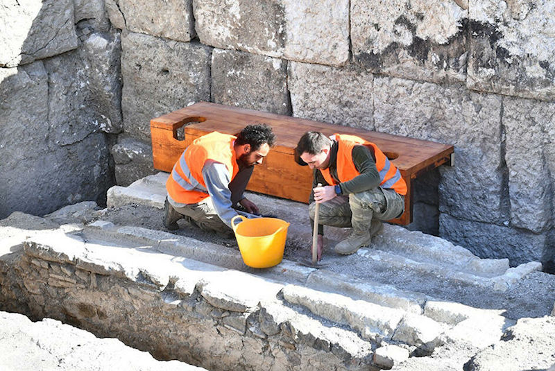 Two archaeologists work on the ancient theater of Smyrna in Türkiye, where a special latrine for artists was uncovered. (Photo via Arkeonews)