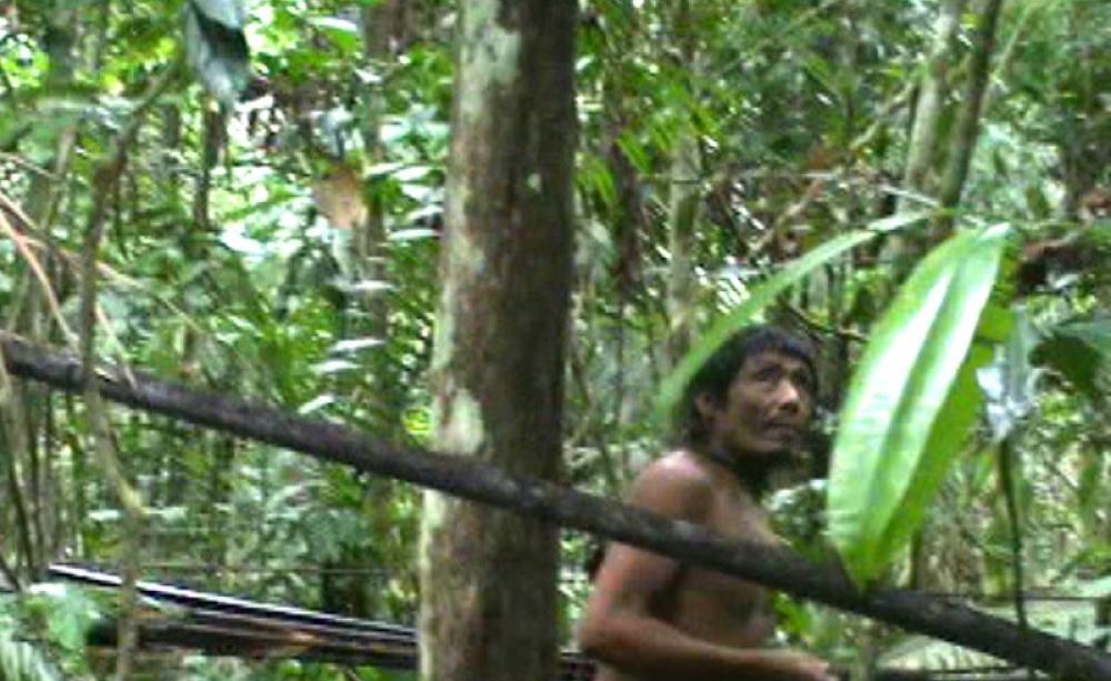 Still from video footage taken by a Brazilian government task force during a chance encounter with a Kawahiva tribe member in his rainforest home. (Photo via FUNAI)
