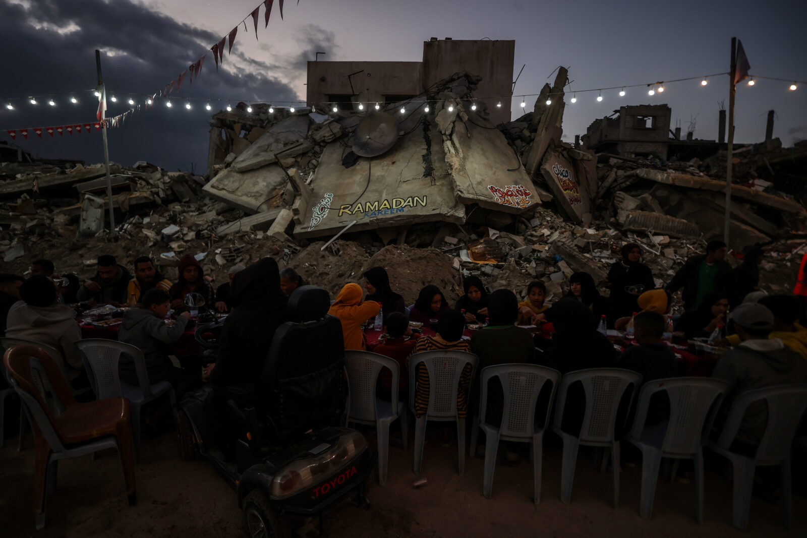 A mass iftar dinner program is organized for Palestinians to break their fast together on the first day of Ramadan 2025 amidst the rubble of a residential area in Rafah, Gaza, Mar. 1, 2025. (AA Photo)