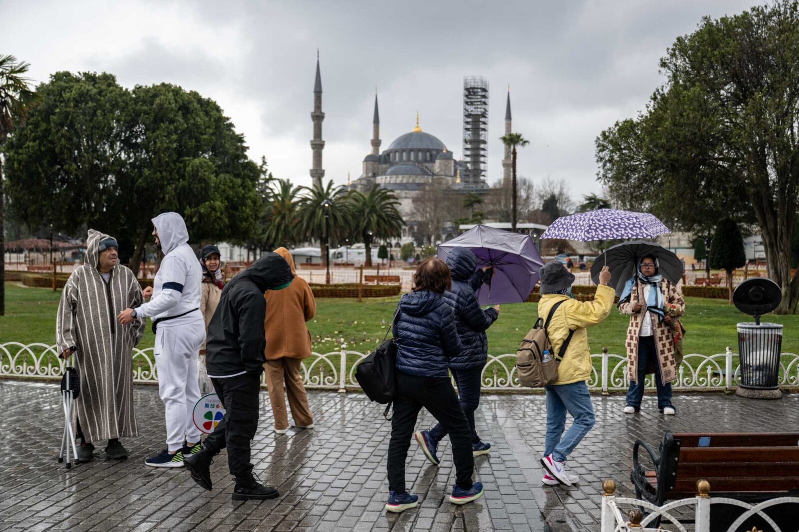 People walk around the Sultanahmet Square on a rainy day in Istanbul, Türkiye on March 18, 2025. (AA Photo)