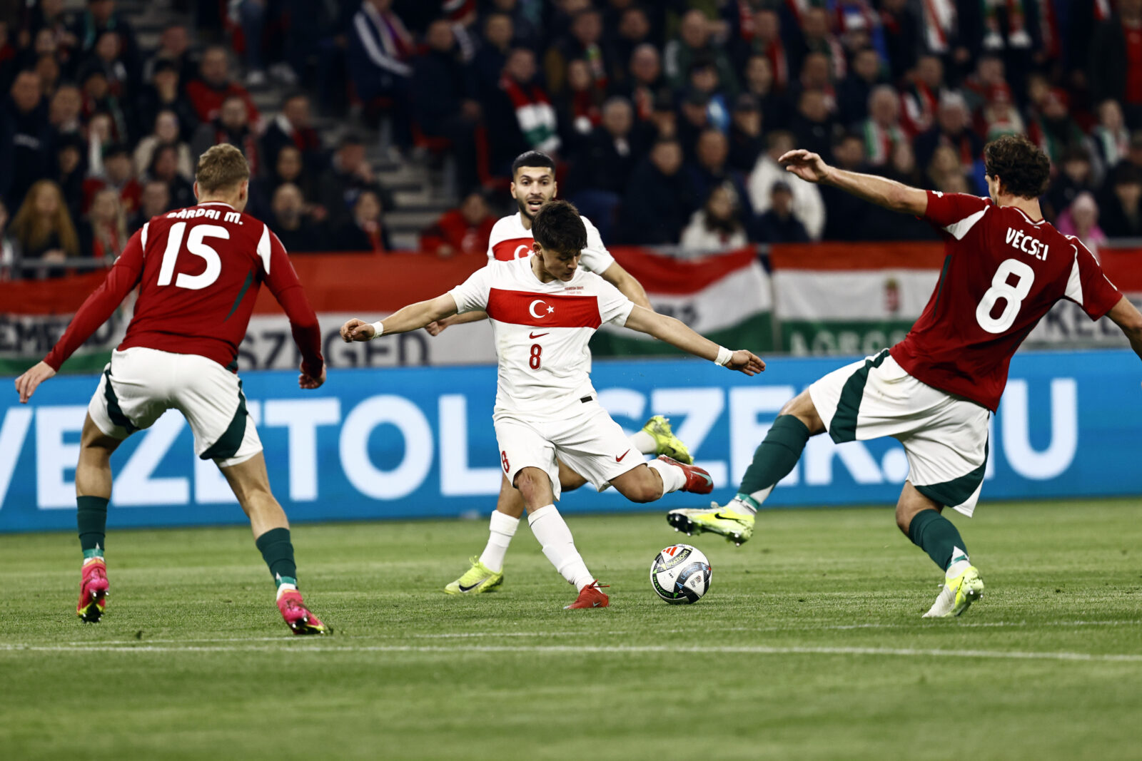 Arda Guler (8) of Turkiye in action against Marton Dardai (15) and Balint Vecsei (8) of Hungary during the UEFA Nations League A/B play-off second leg match between Hungary and Turkiye at Puskas Arena in Budapest, Hungary on March 23, 2025. (AA Photo)