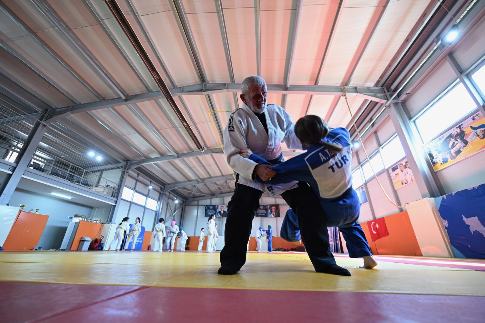 Suleyman Tosun, a 77-year-old from Duzce, has been supporting his hopeful national judoka granddaughter, 17-year-old Aysenaz Tosun, from the stands for many years, now, he brings that support to the mat as they train together. (AA Photo)