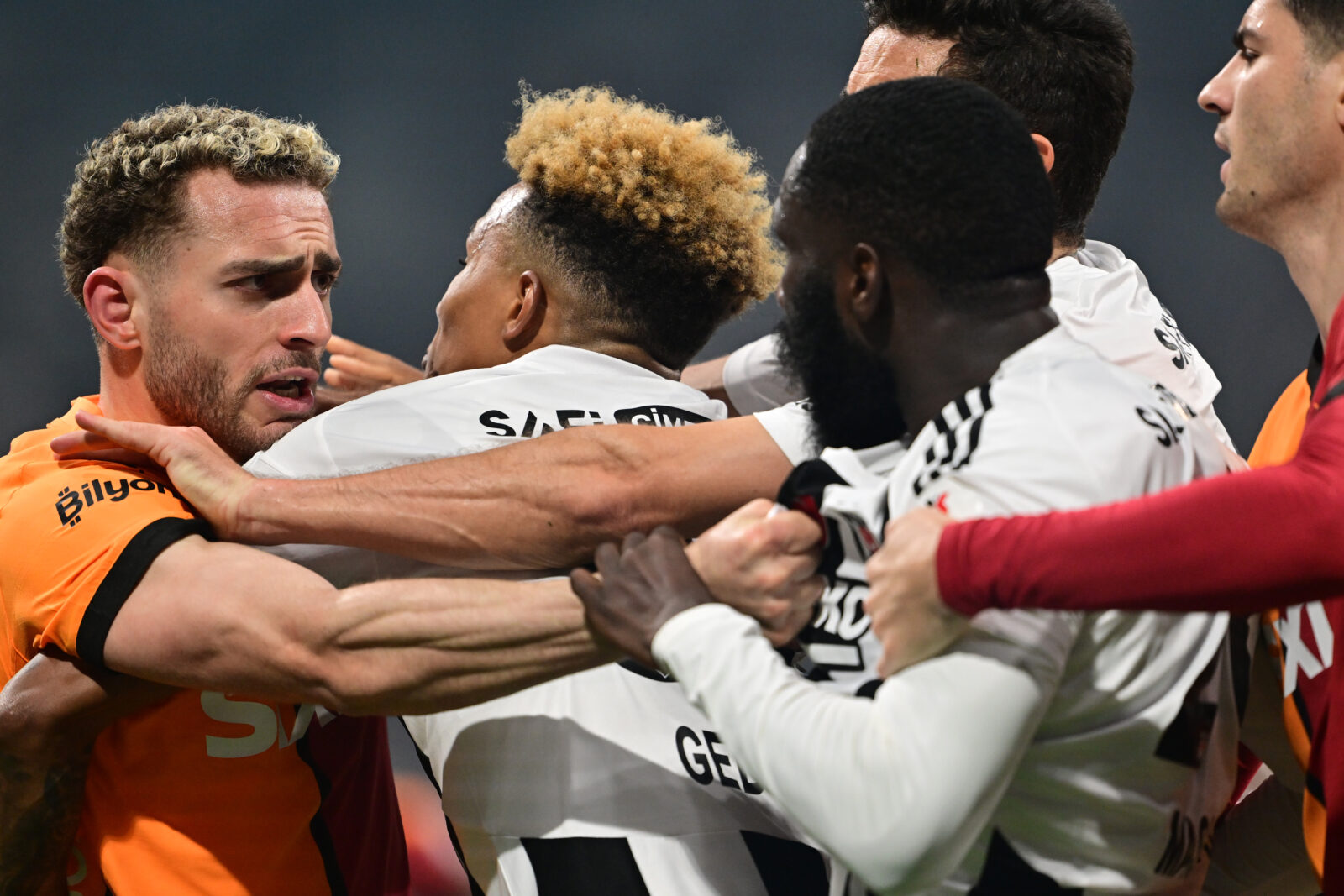 Arthur Masuaku (2nd R) of Besiktas and Baris Alper Yilmaz (L) of Galatasaray get tense after a position during the Turkish Super Lig week 29 football match between Besiktas and Galatasaray at Tupras Stadium in Istanbul, Türkiye on March 29, 2025. (AA Photo)