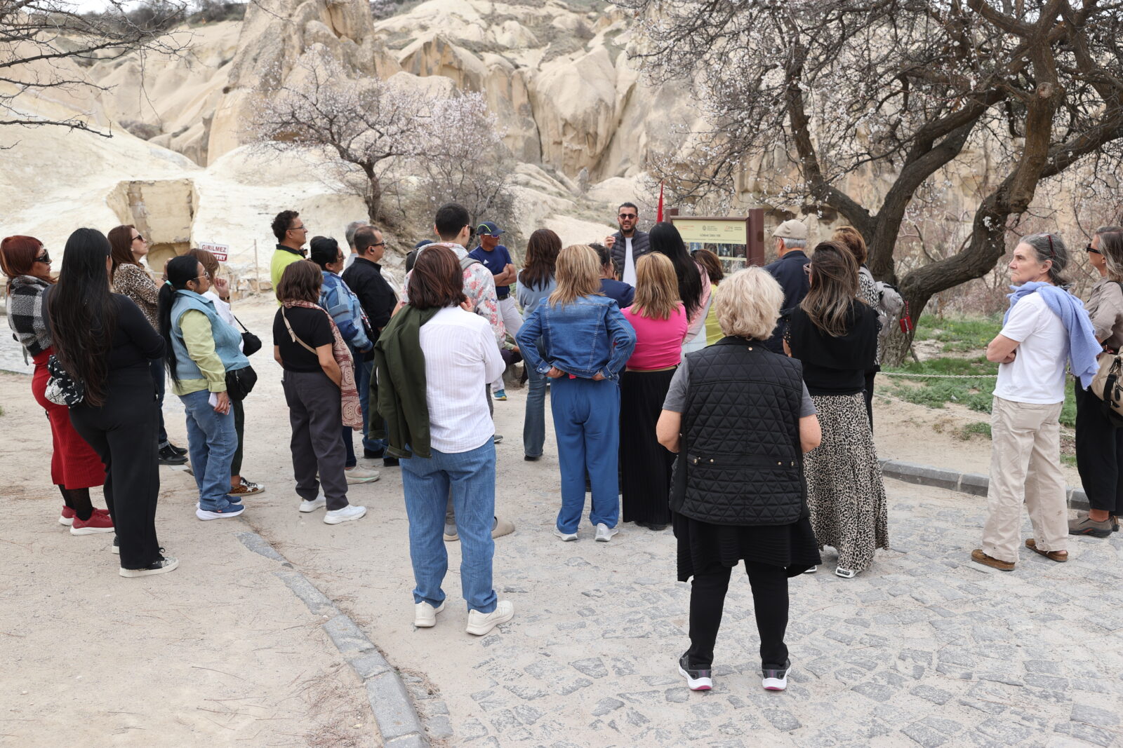 A tour guide speaks to an international group visiting the Göreme Open-Air Museum, a UNESCO-listed site in Cappadocia known for its rock-cut churches and cave dwellings in Nevsehir, Türkiye, on March 30, 2025. (AA Photo)