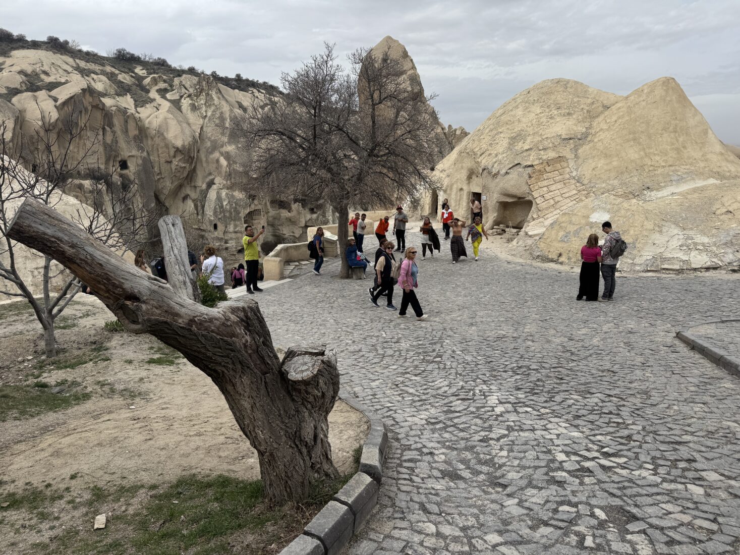 Tourists walk among ancient cave dwellings in Cappadocia's surreal landscape, exploring one of the region’s most visited historical areas in Nevsehir, Türkiye, on Mar. 30, 2025. (AA Photo)