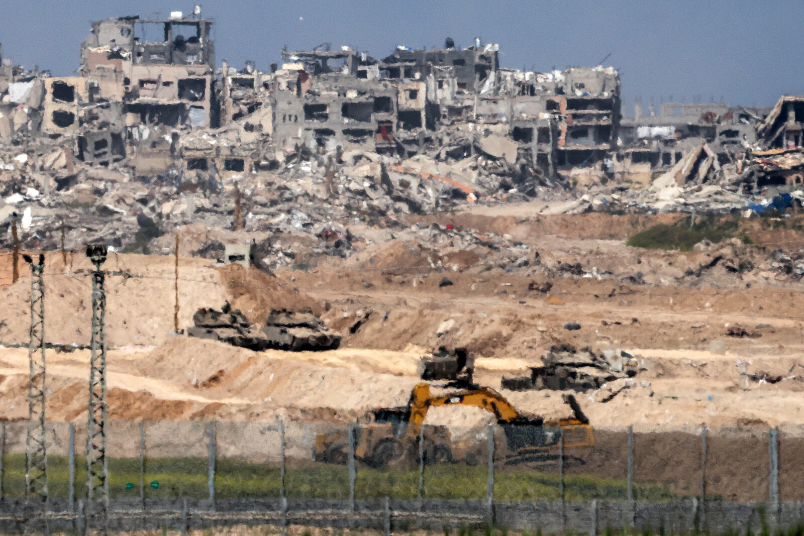 Israeli army battle tanks and excavators are pictured operating in the northern Gaza Strip from across the border in southern Israel on March 18, 2025. (AFP Photo)