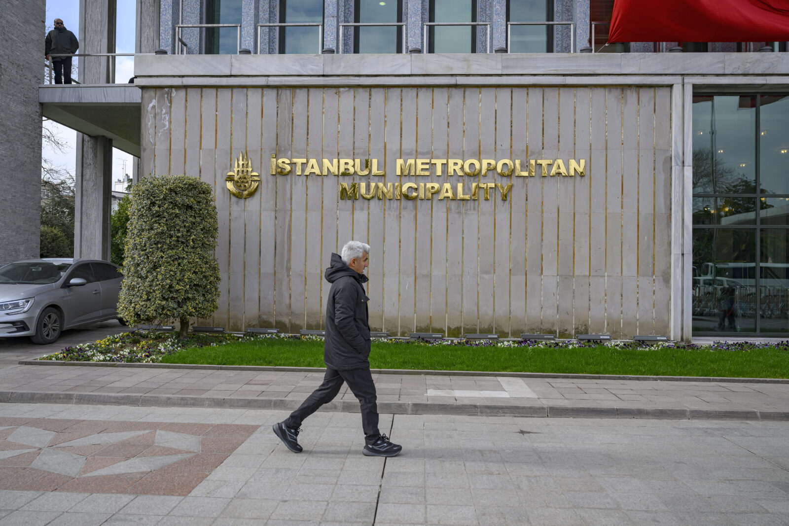 A pedestrian walks in front of the Istanbul Municipality headquarters in Istanbul on March 19, 2025. (AFP Photo)