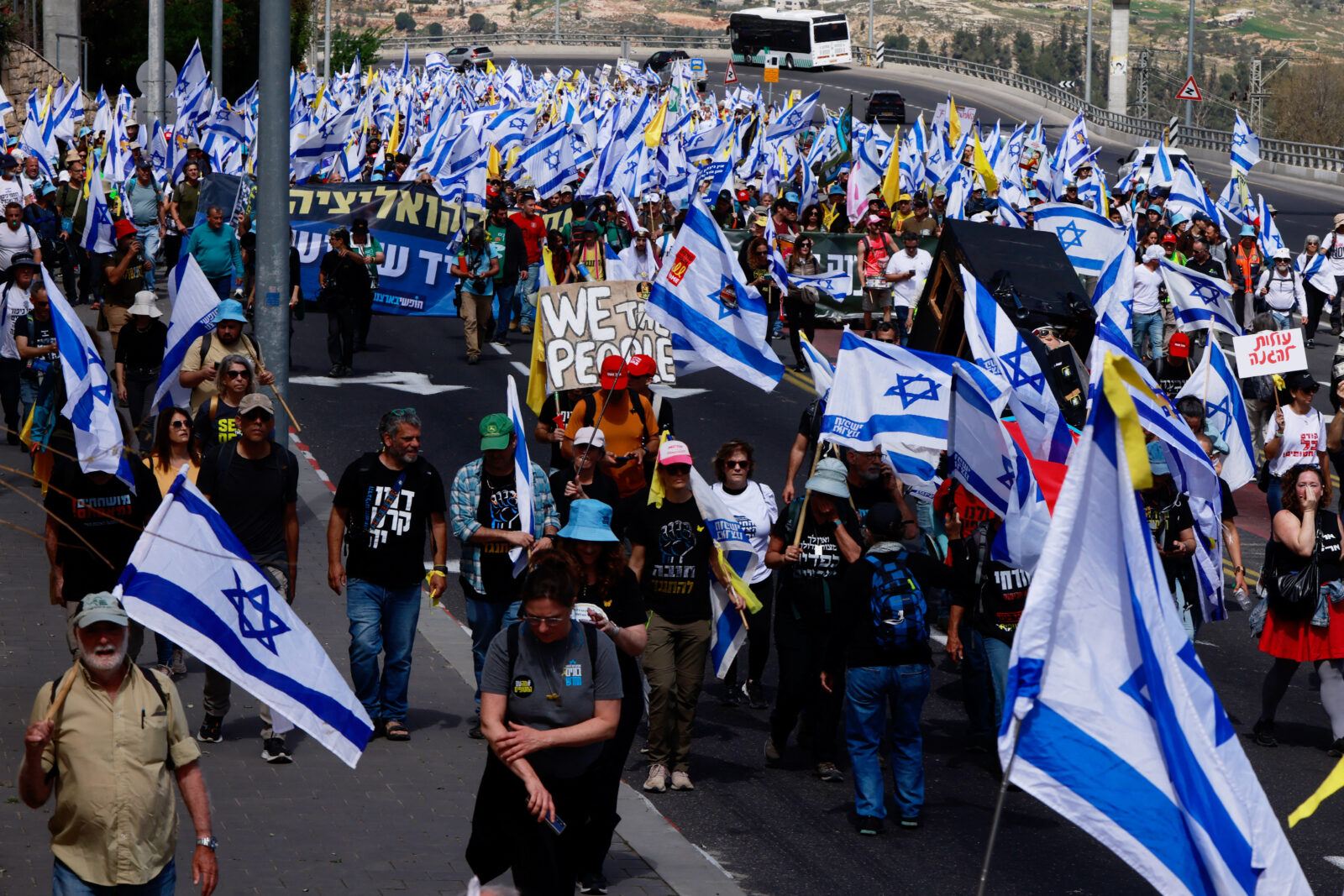 Israelis holding national flags march into Jerusalem during a demonstration against Prime Minister Benjamin Netanyahu and calling for an end to the war in Gaza on March 19, 2025. (AFP Photo)