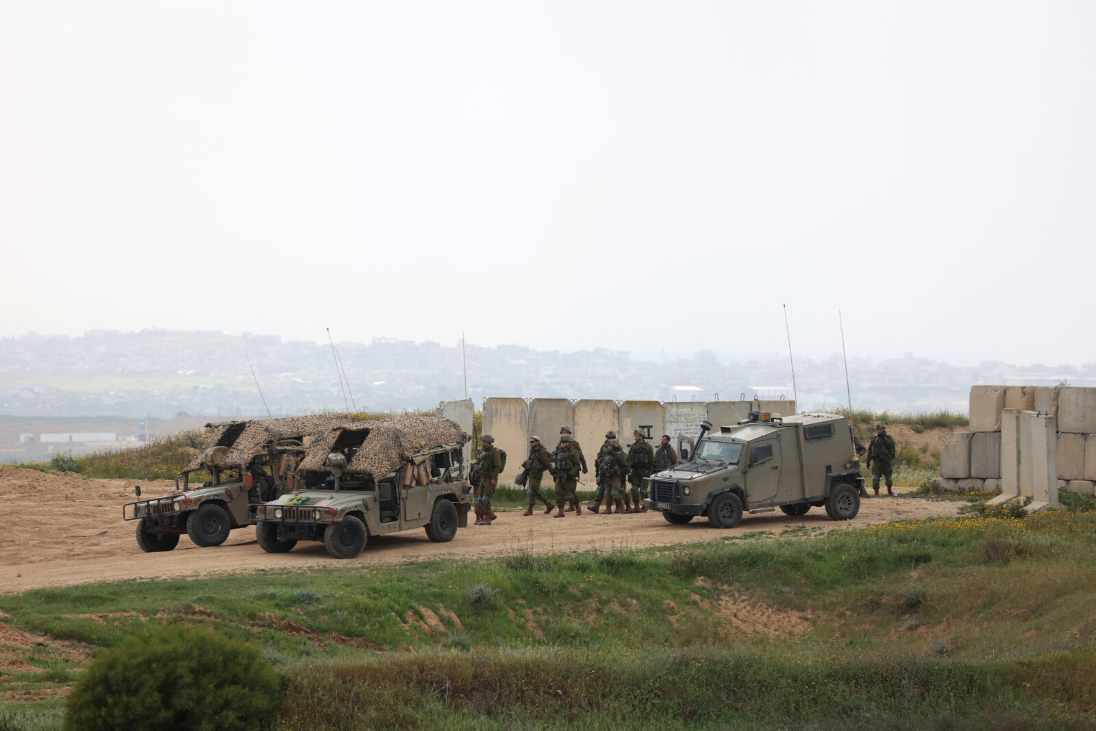 Israeli army soldiers walk in a position along Israel's southern border with the northern Gaza Strip on March 20, 2025. (AFP Photo)