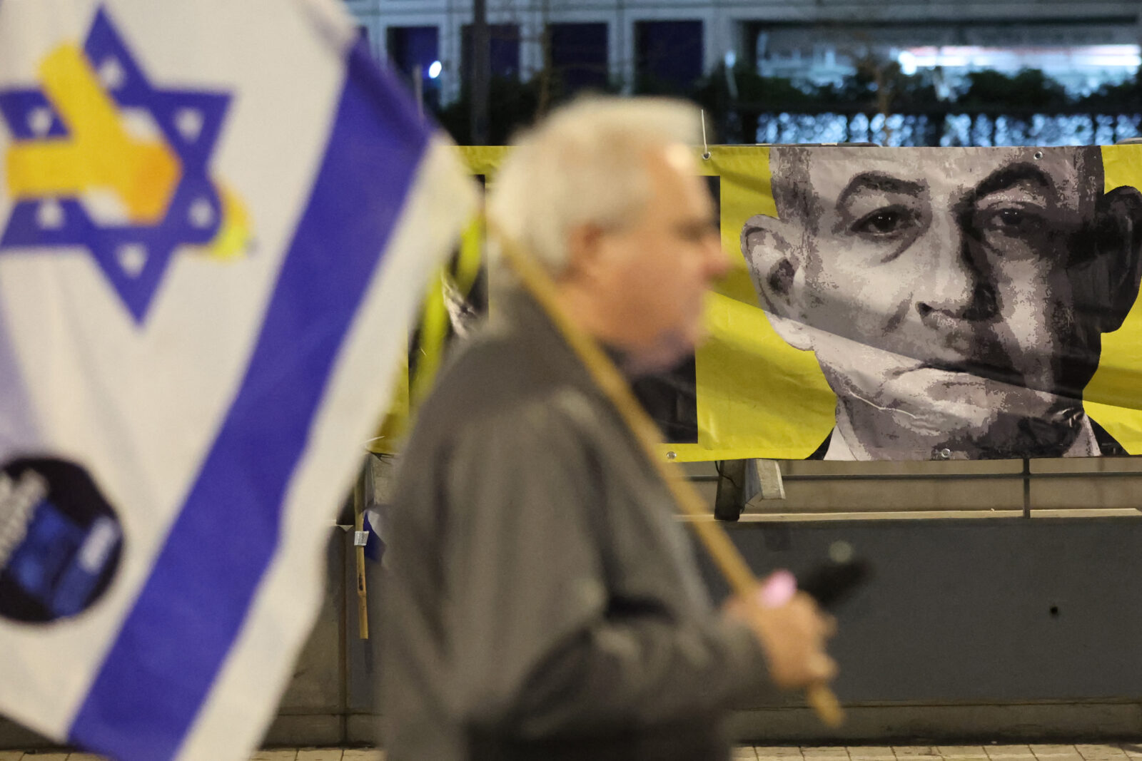 A demonstrator waves the Israeli flag during an anti-government protest calling for action to secure the release of Israeli hostages held captive in front of the Israeli Defence Ministry in the coastal city of Tel Aviv on March 29, 2025 (AFP Photo)