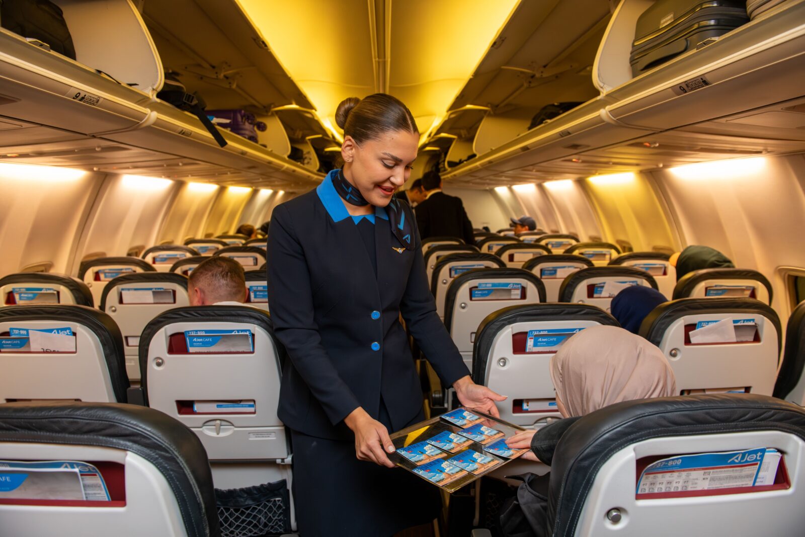 A flight attendant serves a passenger on AJet’s inaugural Istanbul–Bishkek flight on March 24, 2025. (Courtesy of AJet)