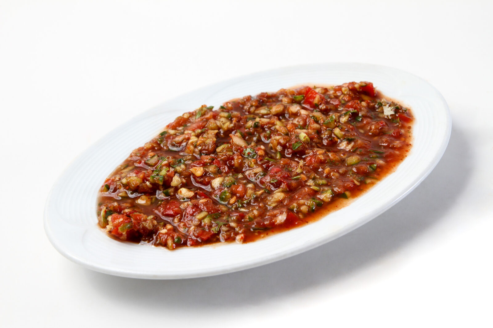Acili ezme, a spicy and tangy tomato-pepper dip, served as a bold appetizer to wake up the palate before the iftar meal. (Adobe Stock Photo)