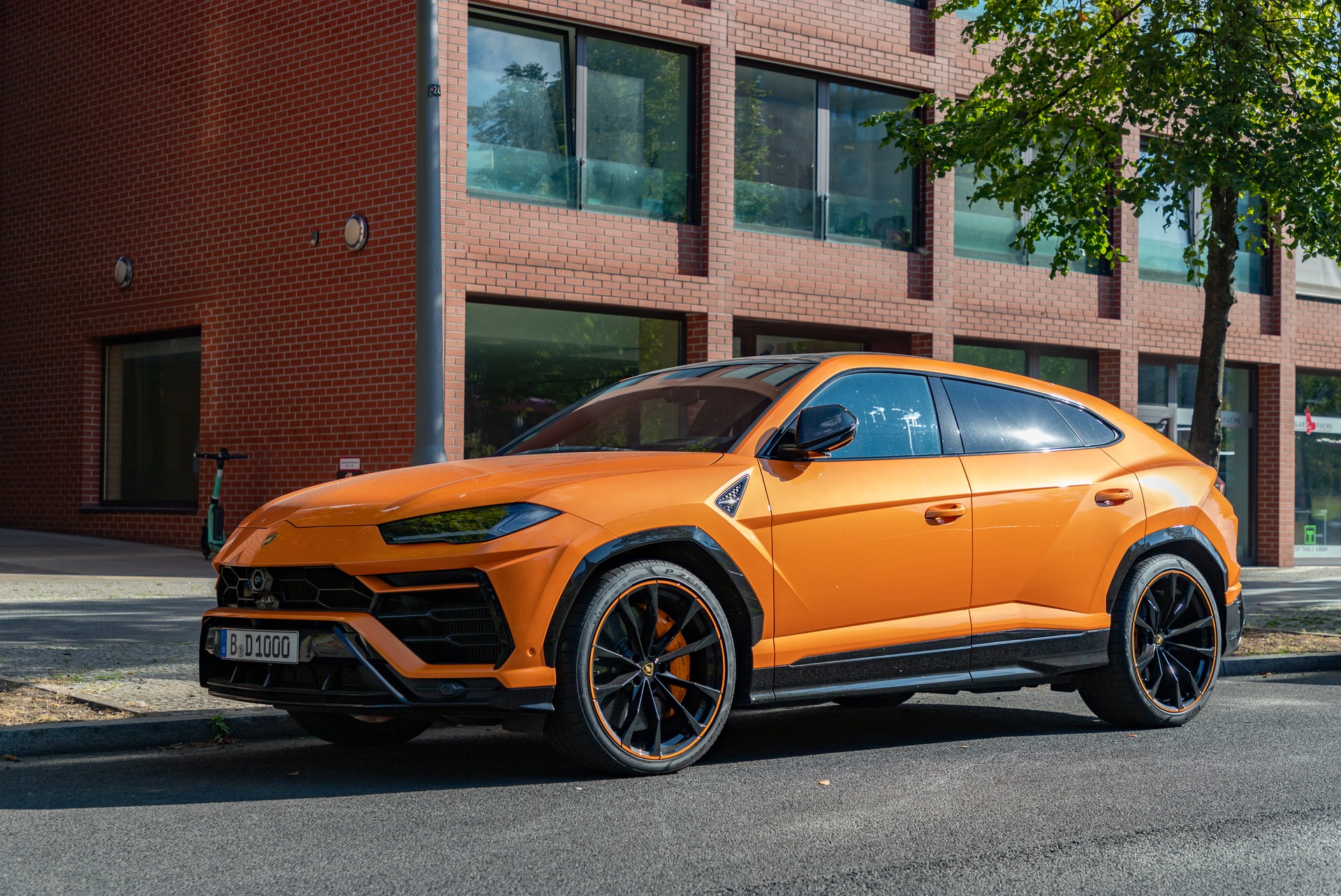 Promotional photo shows an orange Lamborghini Urus parked on a city street, the brand's best-selling model in 2024 with over 5,600 units delivered worldwide, accessed on Mar. 23, 2025. (Adobe Stock Photo)