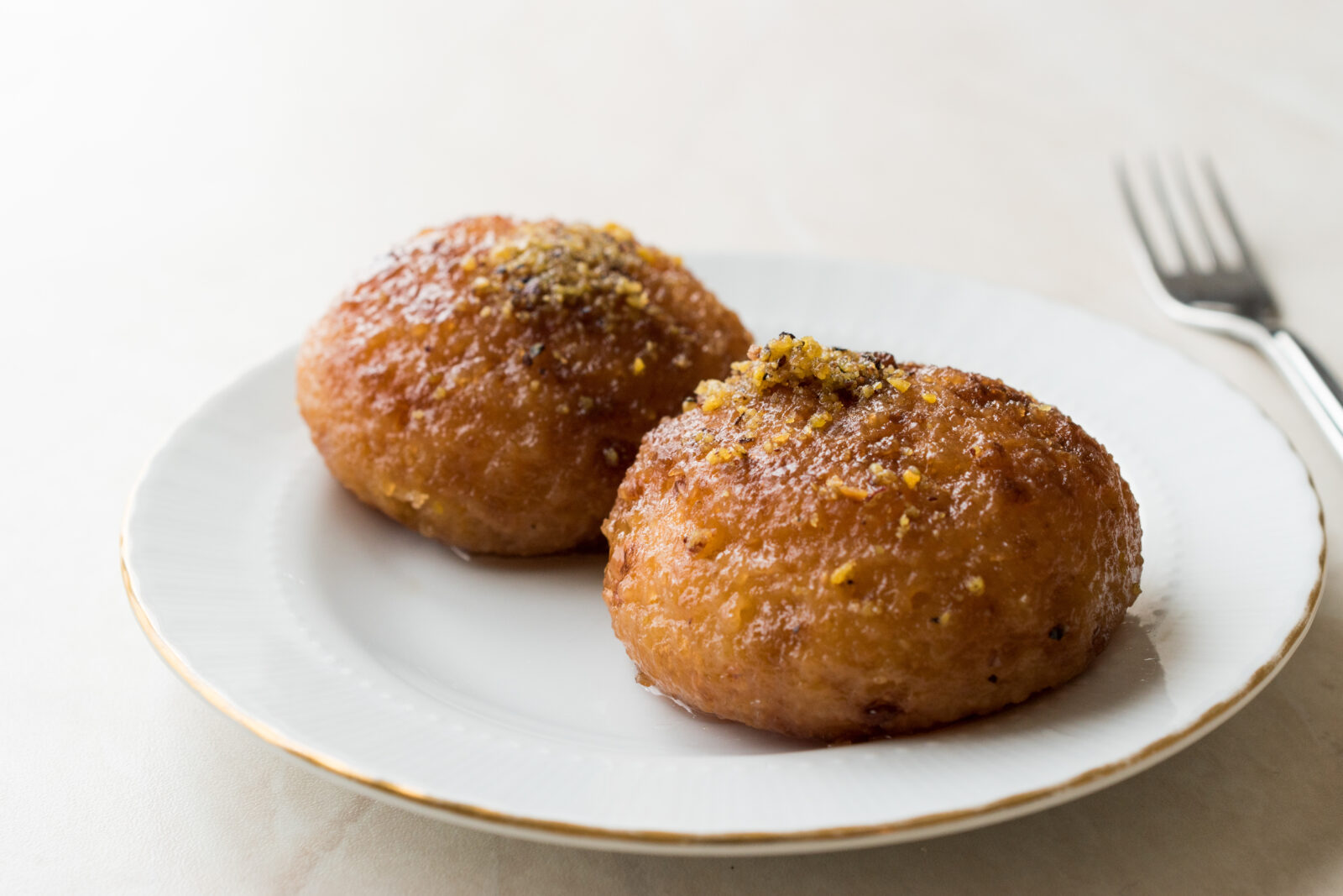 Golden-brown Turkish lor tatlisi, a sweet cheese pastry soaked in syrup, is the perfect dessert to break fast with. (Adobe Stock Photo)