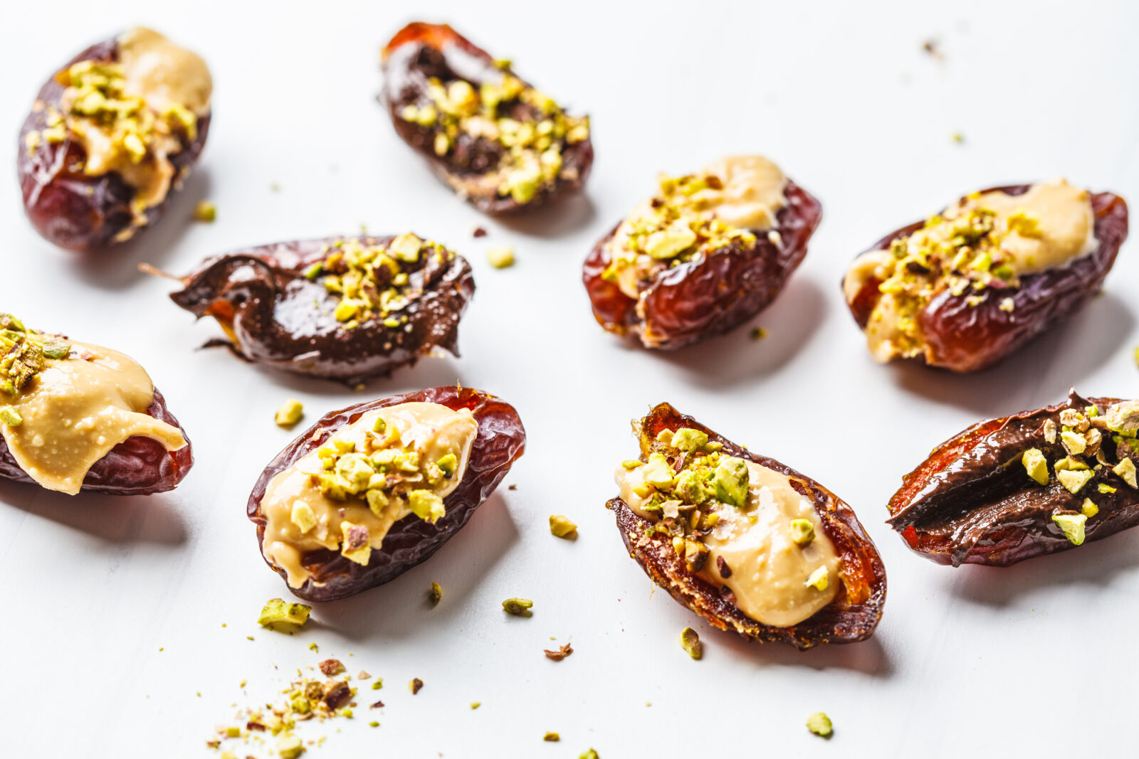 Naturally sweet stuffed dates filled with walnuts and drizzled with tahini, a simple and nutritious dessert for iftar. (Adobe Stock Photo)