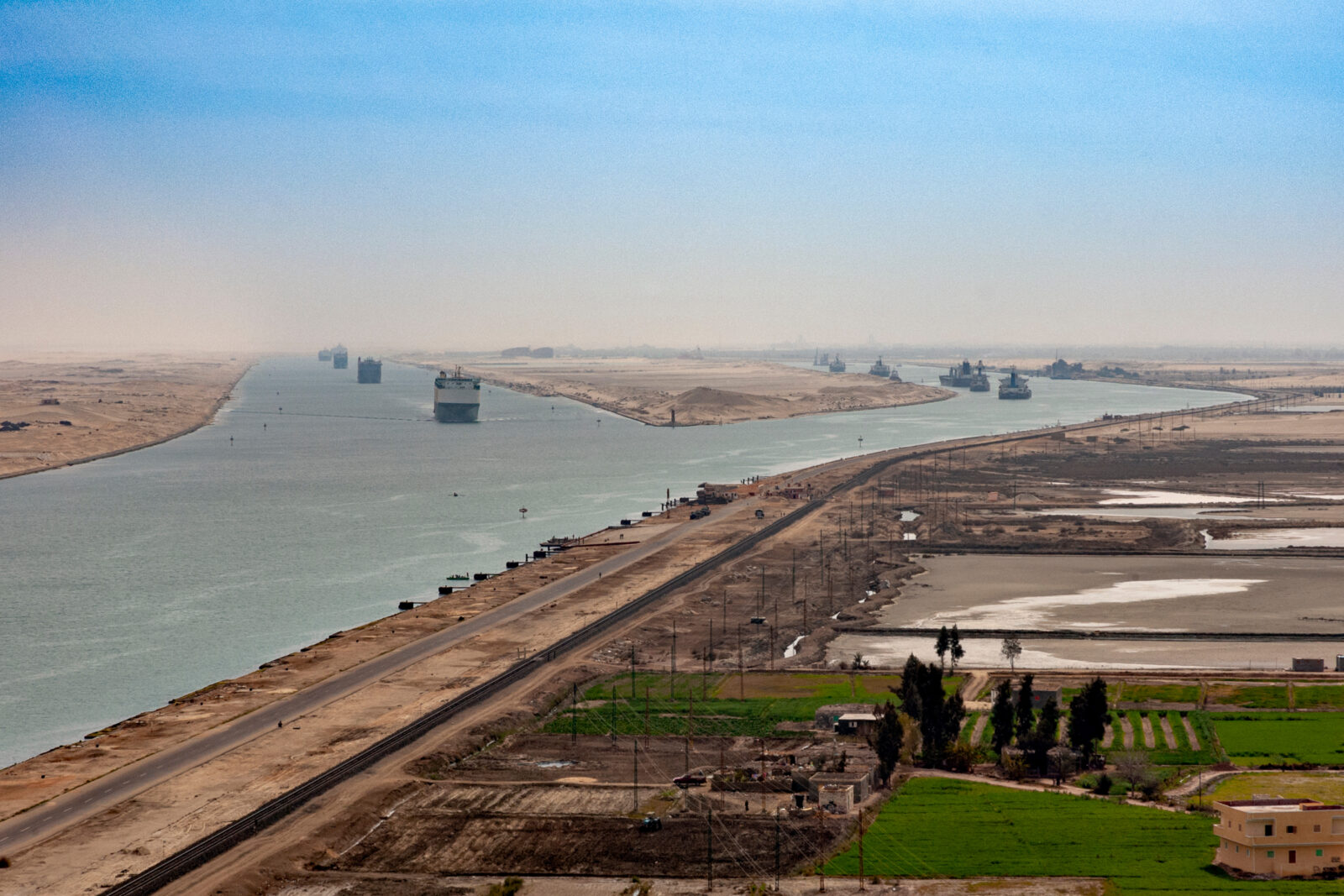 Aerial view of the Suez Canal with multiple cargo ships navigating the waterway in Egypt, accessed on Mar. 18, 2025. (Adobe Stock Photo)