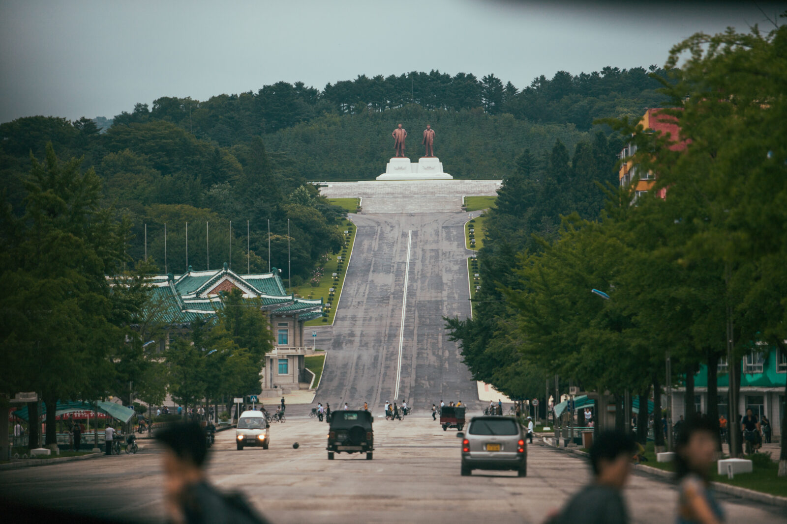 Photo of an updated statue of Kim Il-sung depicting him as an older, smiling statesman wearing a Western suit, and an additional statue of Kim Jong-il. (AFP Photo)