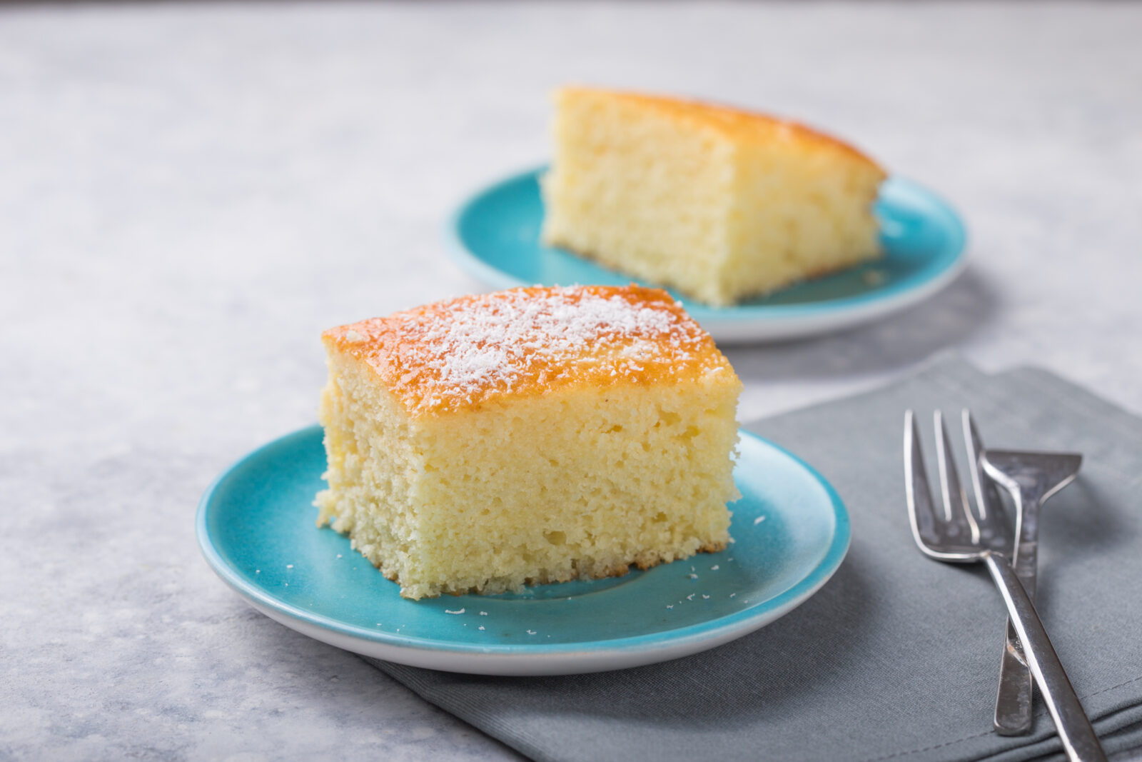 A light and moist slice of Turkish revani, a traditional semolina cake soaked in syrup. (Adobe Stock Photo)