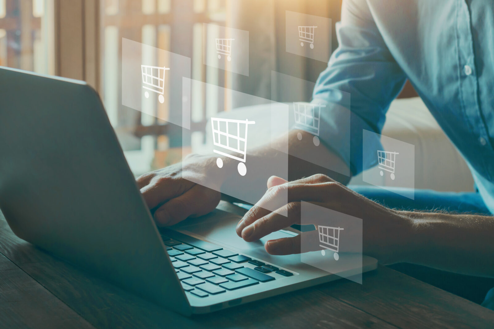 A shopping cart filled with packages and bags on a laptop, reflecting online purchases in Türkiye. (Adobe Stock Photo)