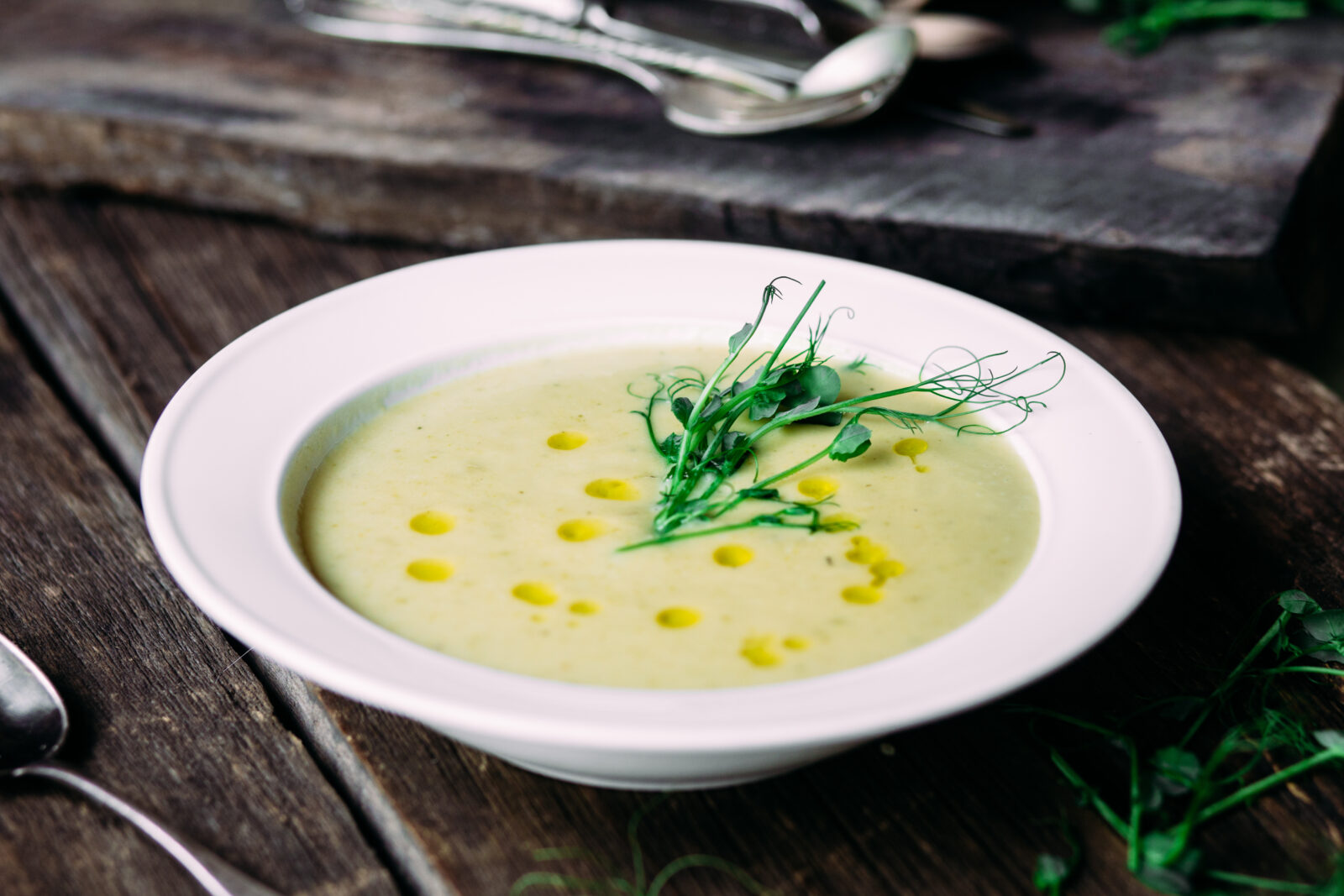 A bowl of creamy yogurt and chickpea soup garnished with fresh herbs and olive oil, perfect to start your iftar meal with. (Adobe Stock Photo)