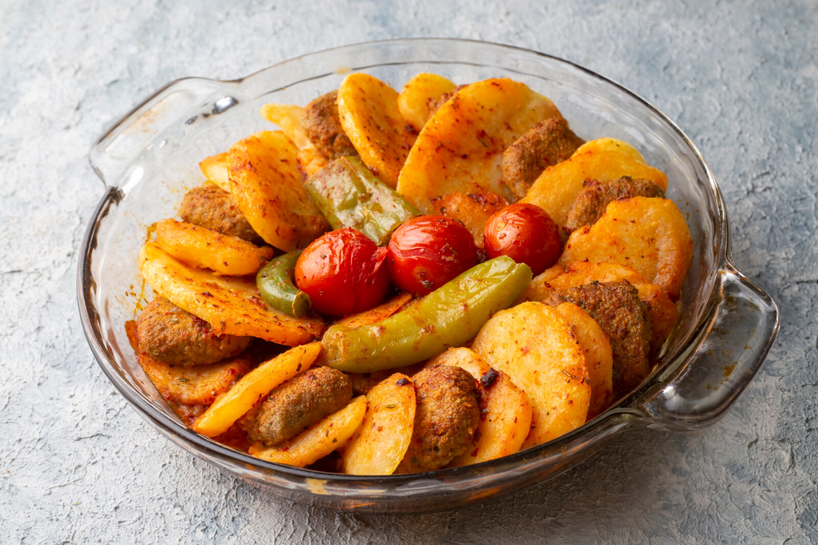 Oven-baked Turkish meatballs with potatoes are a comforting dish that makes for a satisfying iftar meal. (Adobe Stock Photo)