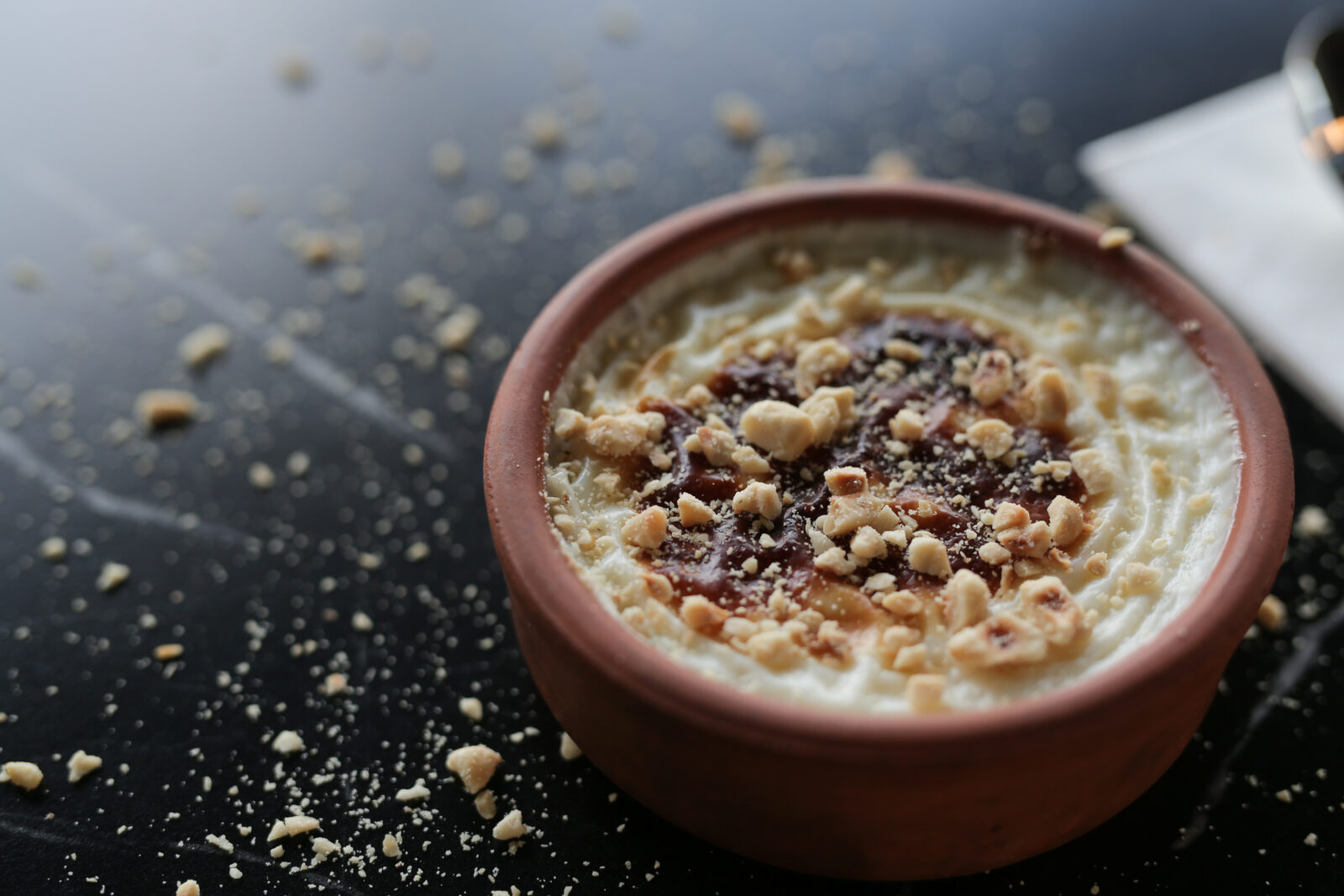 A comforting and creamy oven-baked Turkish rice pudding, topped with toasted hazelnuts for a delightful crunch. (Adobe Stock Photo)