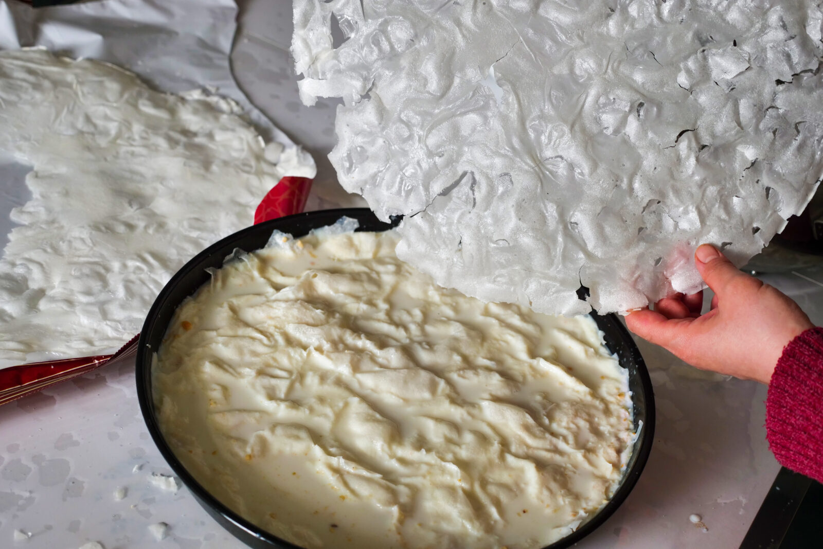 A woman preparing the dessert gullac with 