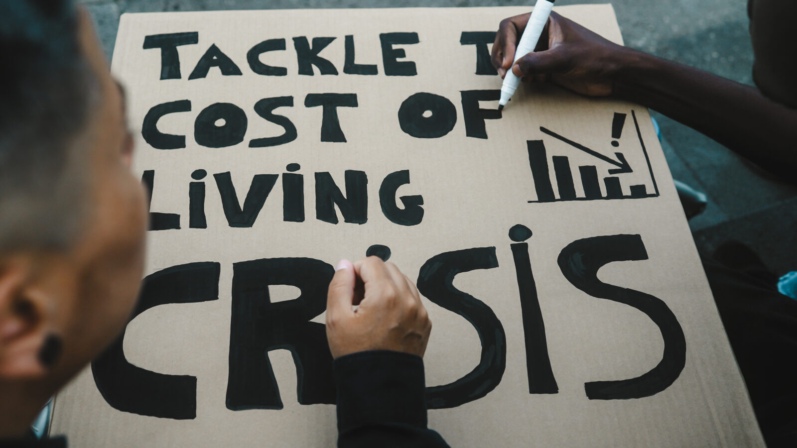 Activists preparing protest banners against the financial crisis and global inflation. (Adobe Stock Photo)