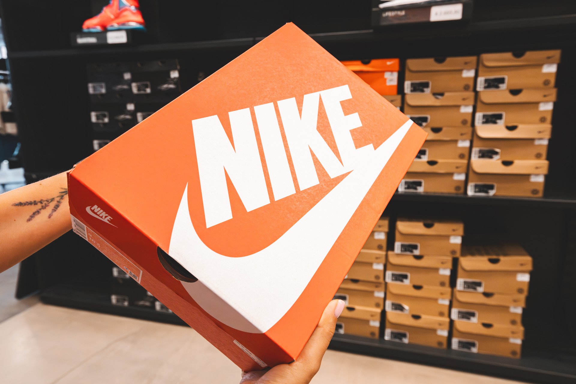 Woman holding box while choosing sports shoes at Nike store in Antalya, Türkiye, Aug. 17, 2022. (Adobe Stock Photo)