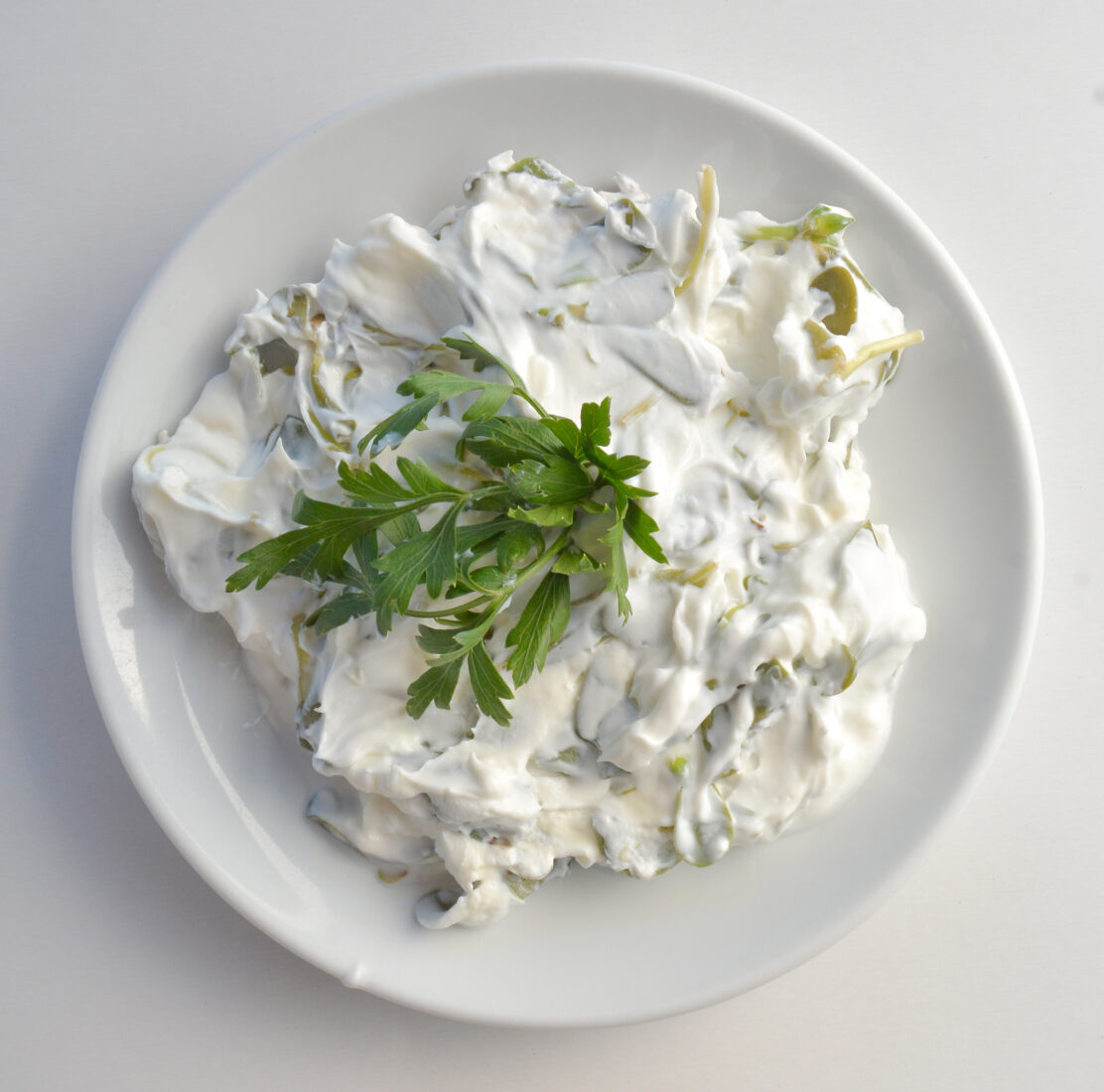 Yogurt-based purslane salad, a refreshing and creamy Turkish meze made with strained yogurt, garlic, and fresh purslane. (Adobe Stock Photo)