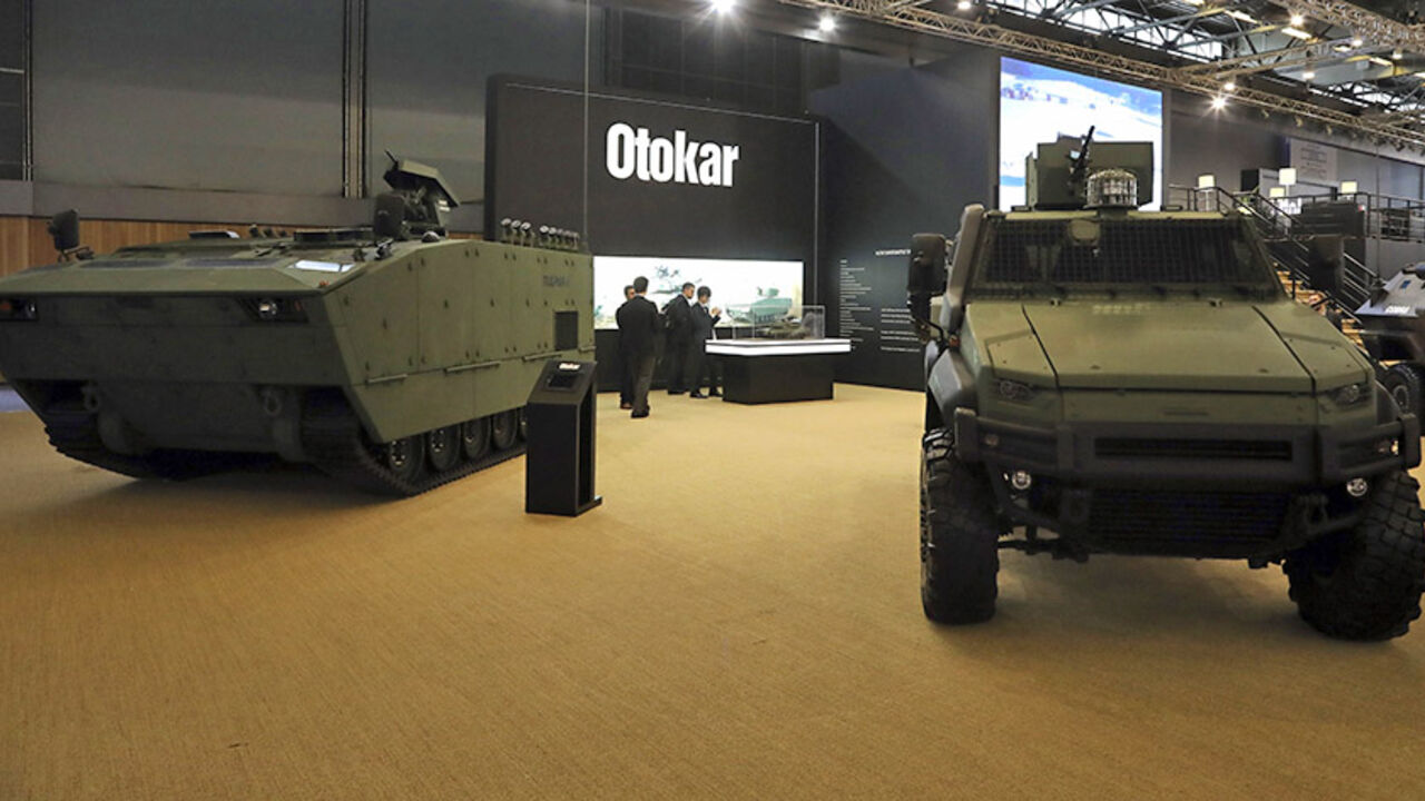 People stand near by military vehicles displayed by Turkish company Otokar on June 13, 2016 during the the Eurosatory defence and security international exhibition in Villepinte, near Paris (Photo Jacques Demarthon /AFP/ Getty Images)