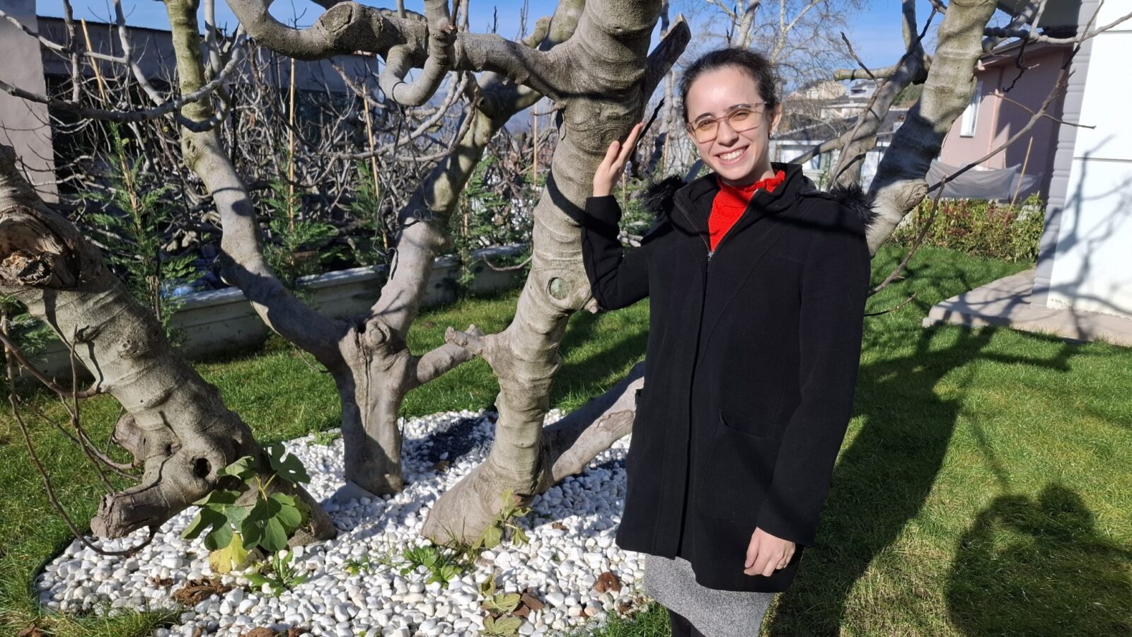 Sila Ozkan, an agricultural engineer and entrepreneur, stands next to a fig tree in Bursa, Türkiye, Mar. 7, 2025. (Photo by Dilek Atli)