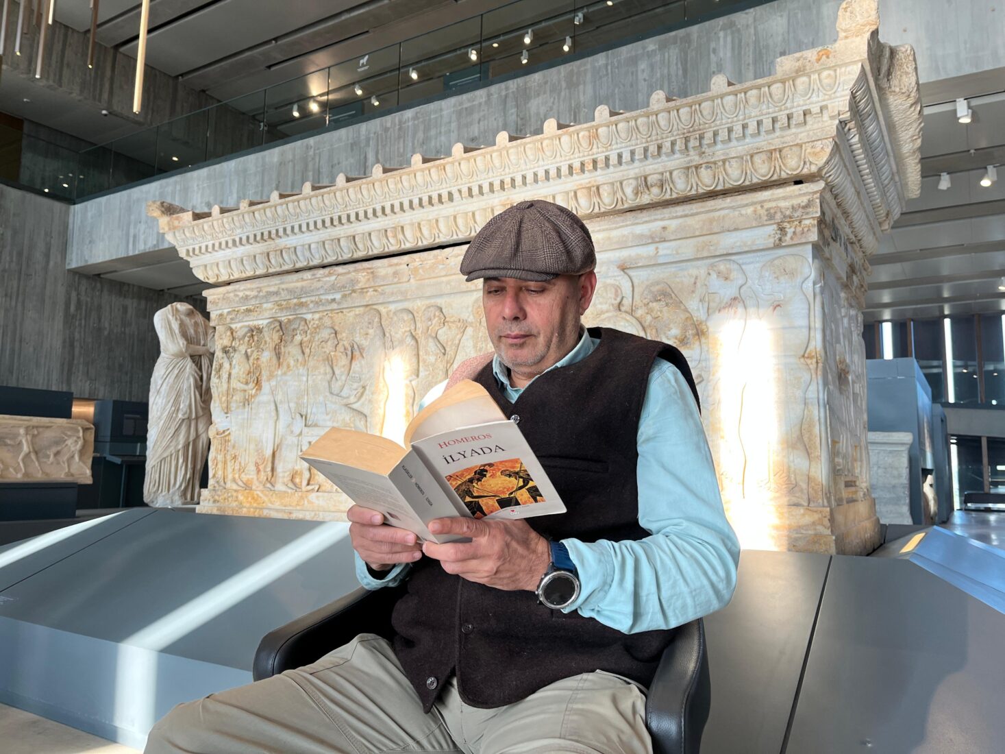 A participant reads Homer's Iliad in front of the Polyxena Sarcophagus, Troy Museum, Canakkale, Türkiye, March 21, 2025. (Photo via Troy Museum)