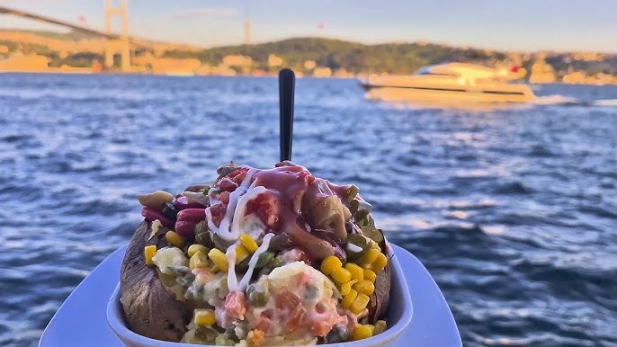 A Kumpir (stuffed baked potato) with a Bosphorus view, Ortakoy, Istanbul, Türkiye. (Photo via Sudenaz Official YouTube channel)