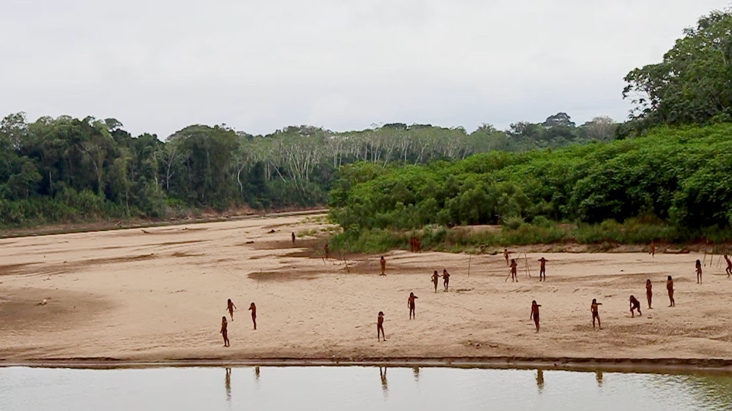 This June 2024 photo provided by Survival International shows members of the Mashco Piro along Las Piedras River in the Amazon near the community of Monte Salvado, in Madre de Dios province, Peru. (Photo via Survival International)