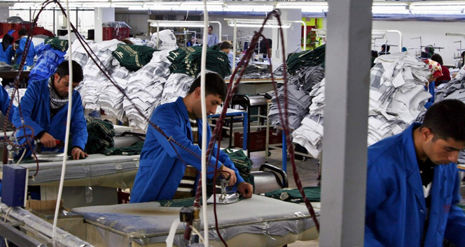 Teen workers operate ironing stations in a textile factory in Türkiye, accessed on April 19, 2025. (IHA Photo)