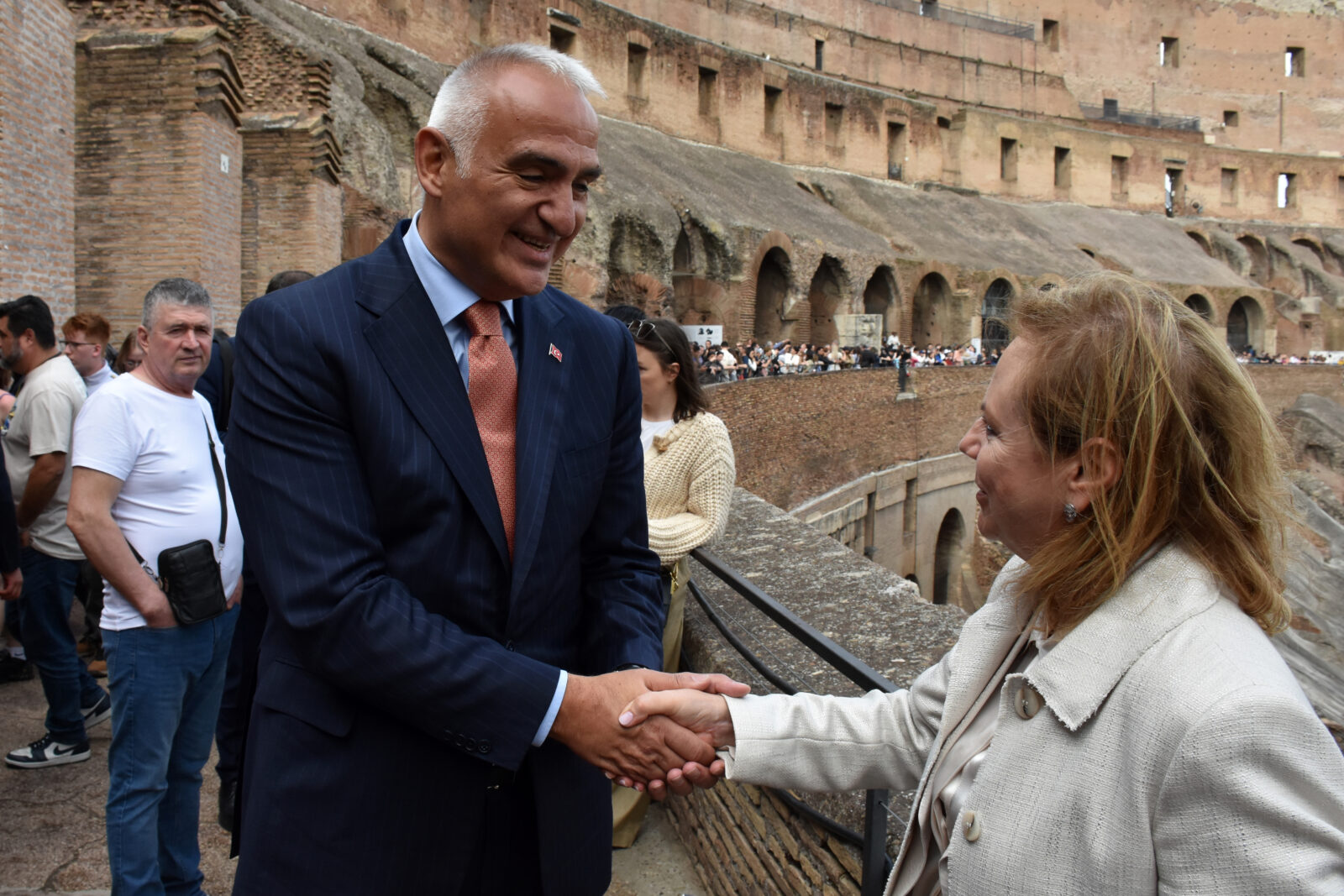 Türkiye’s Minister of Culture and Tourism Mehmet Nuri Ersoy (L) greets Director of the Colosseum and Roman Forum Archaeological Site Alfonsina Russo (R) following the closing ceremony for the exhibition titled 