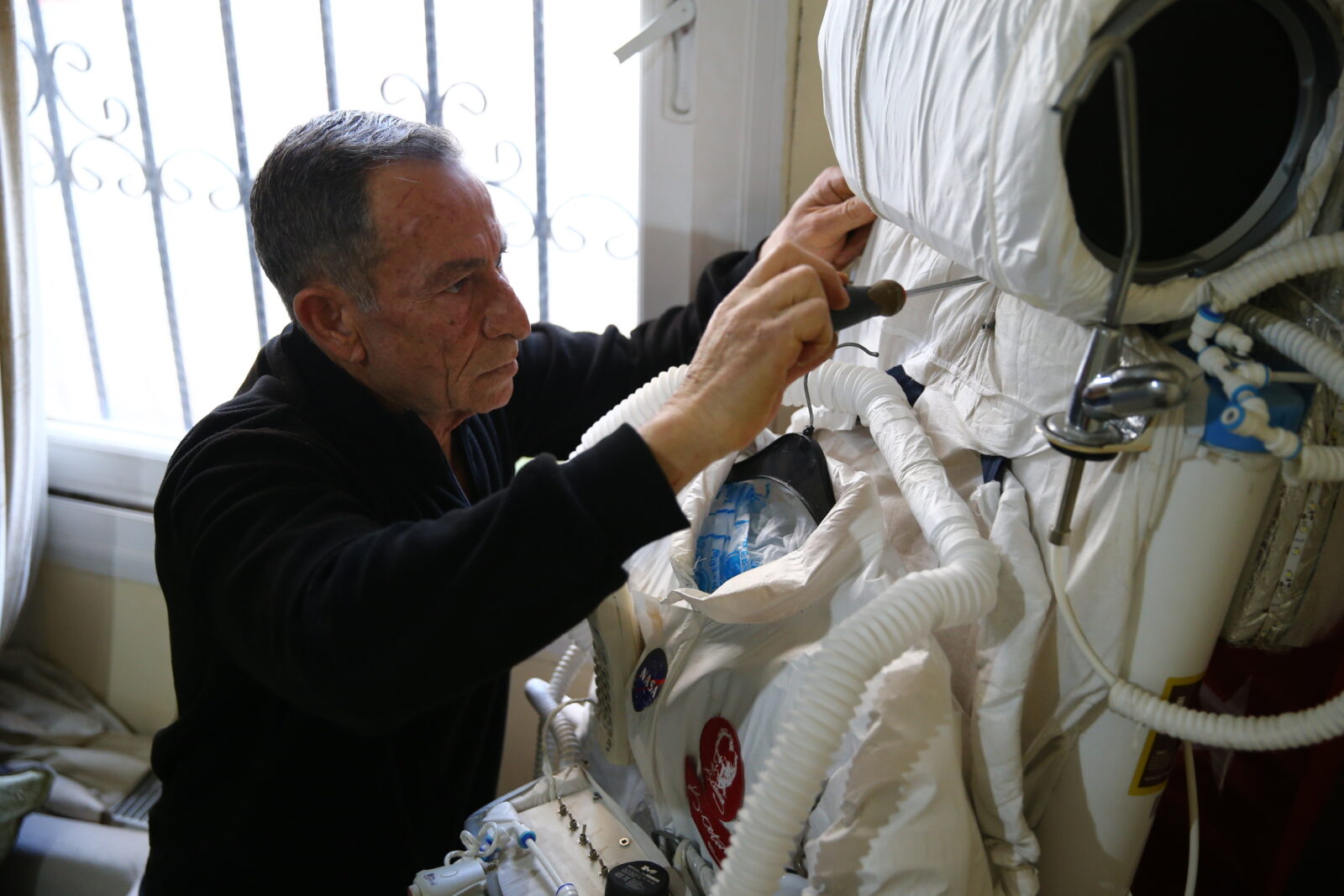 In Mersin, tradesman Zeki Konuk prepares an astronaut costume made from recycled materials. (AA Photo)