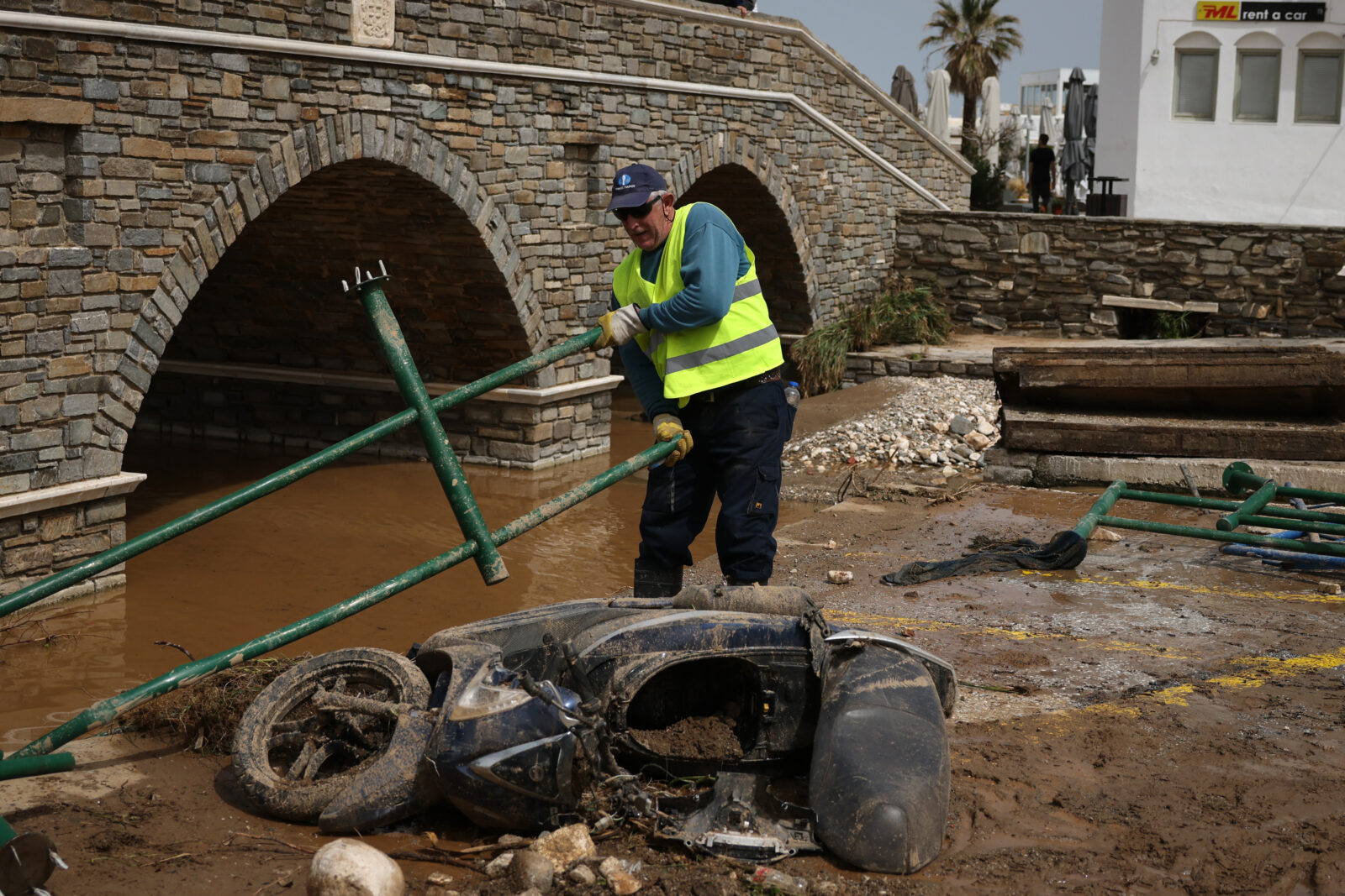 A man removes a rail, after heavy rainstorms flood roads, on Island of Paros, Greece on April 1, 2025. ( Costas Baltas - Anadolu Agency )