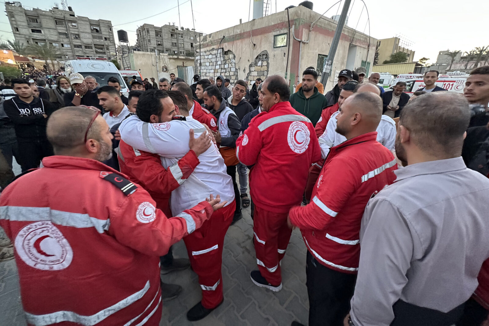 First responders embrace each other at Nasser Medical Complex in Khan Yunis in the southern Gaza Strip on March 30, 2025 as the bodies of Palestinian first responders who were killed a week before in Israeli military fire on ambulances arrive at the facility. (AFP Photo)