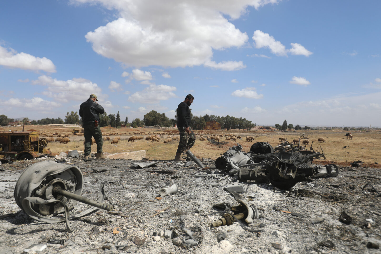 Men check the scene of an Israeli strike in Syria's southern Hama governorate, April 3, 2025. (AFP Photo)