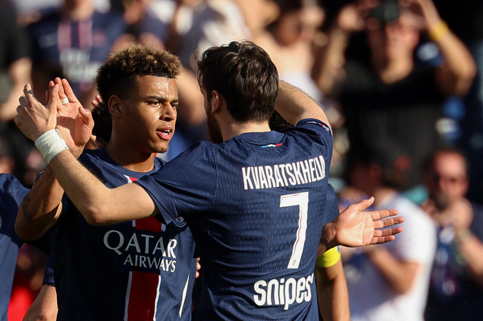 Paris Saint-Germain's French midfielder #14 Desire Doue (L) celebrates with teammates after scoring his team's first goal during the French L1 football match between Paris Saint-Germain (PSG) and SCO Angers at The Parc des Princes Stadium in Paris on April 5, 2025. (AFP Photo)