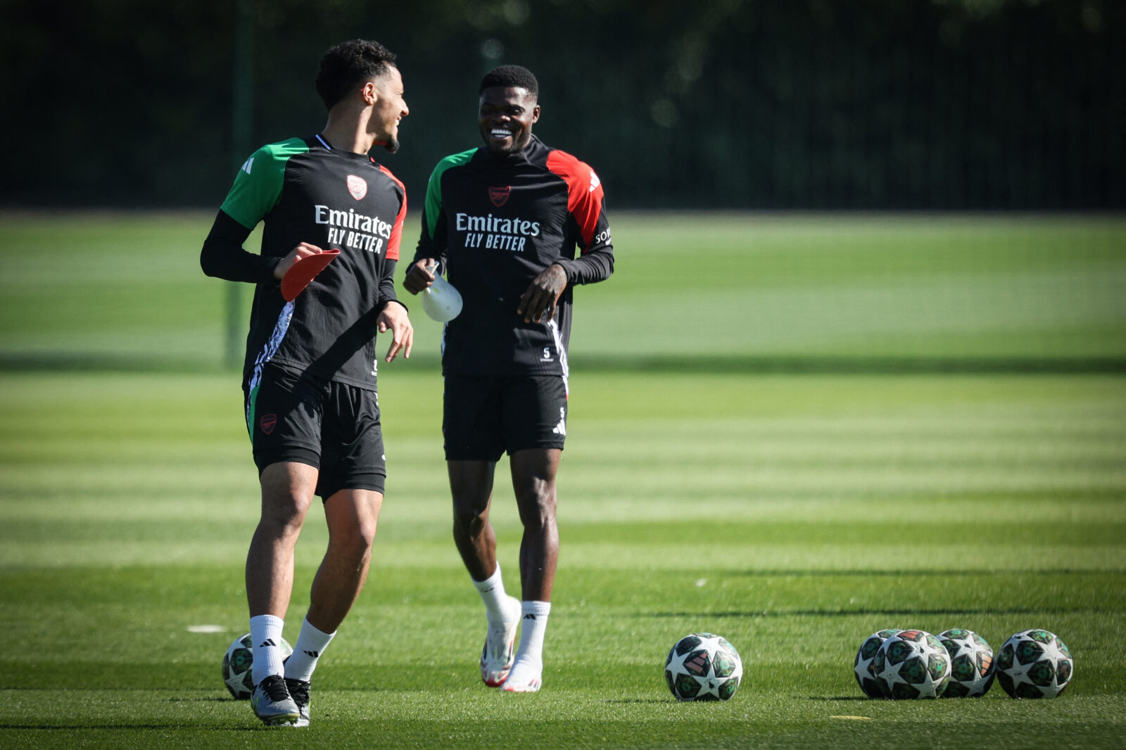 Arsenal's French defender #02 William Saliba (L) and Arsenal's Ghanaian midfielder #05 Thomas Partey (R) take part in a training session at the Arsenal Training centre in Shenley on April 7, 2025. (AFP Photo)