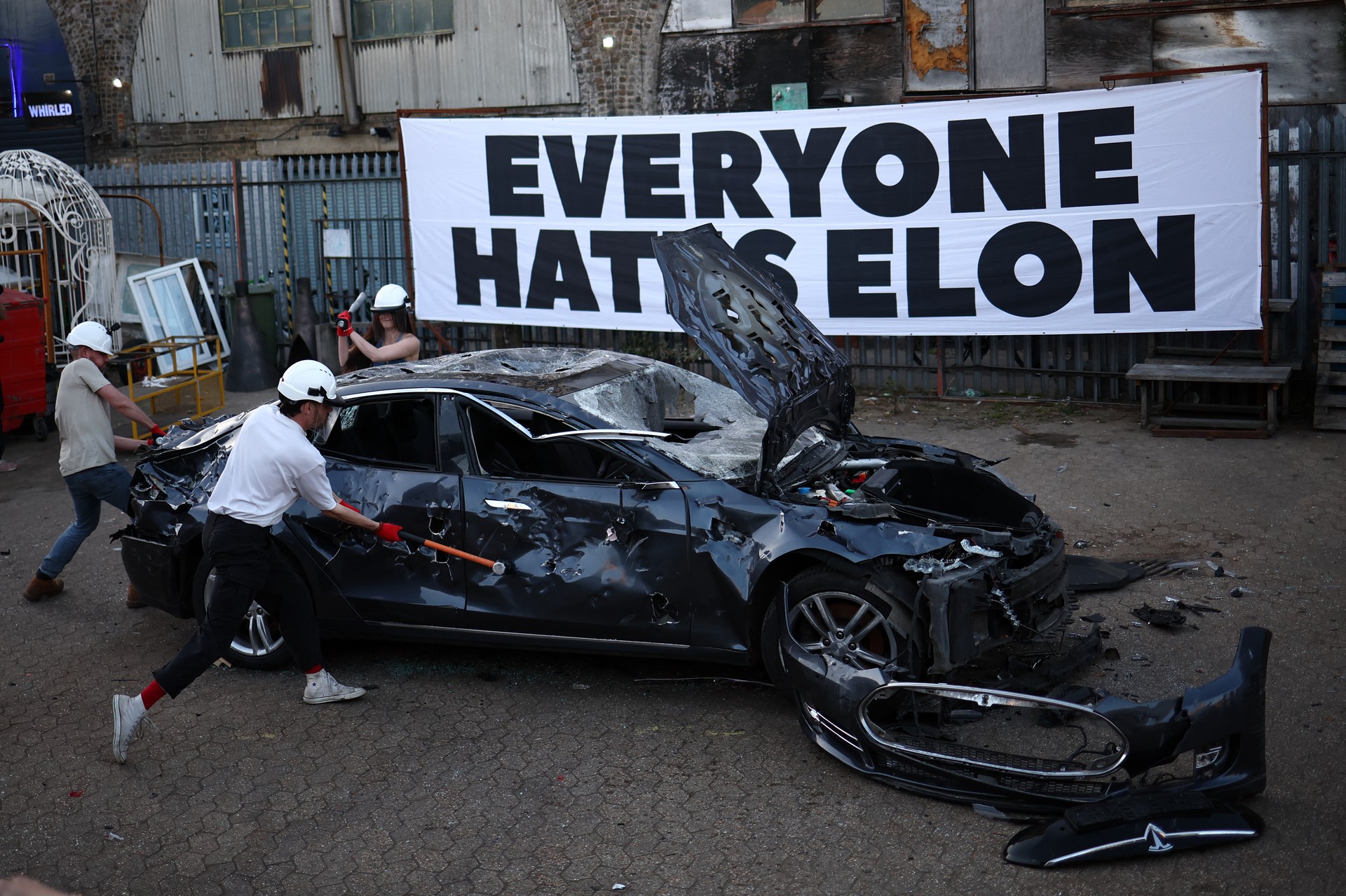 Tesla car burned in London protests by Everyone Hates Elon group