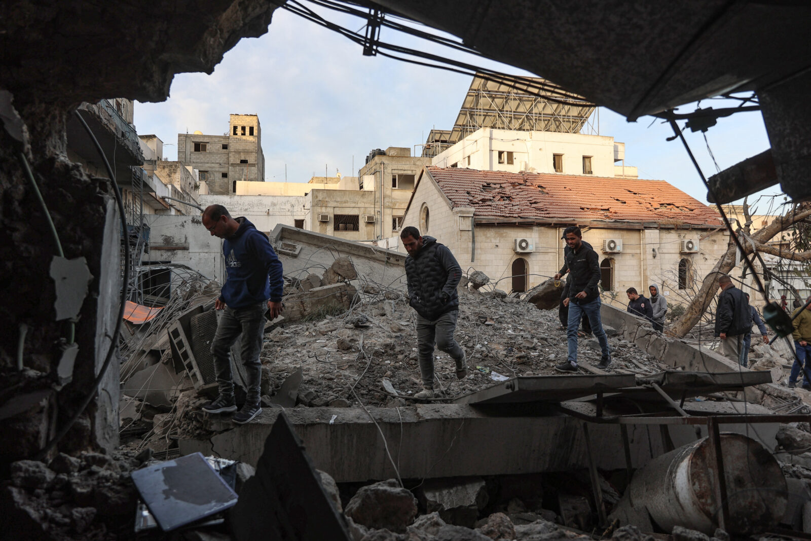 People check the destruction in the aftermath of an Israeli strike on the Al-Ahli hospital, also known as the Baptist or Ahli Arab hospital, in Gaza City on April 13, 2025. (AFP Photo)